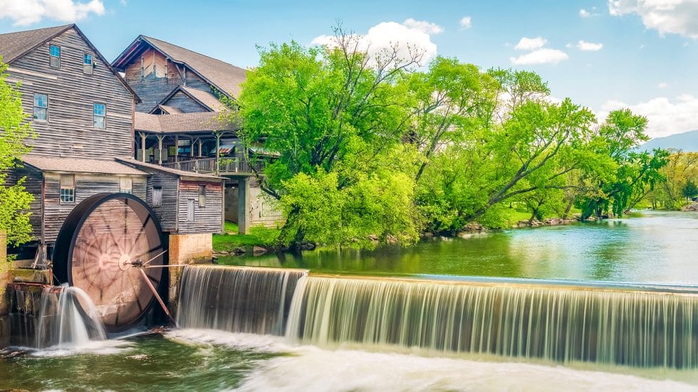 Vacation Travel Innovation Reviews scenic fall travel image with a historic mill and river near the Great Smoky Mountains region.